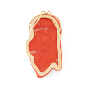 Pendentif en corail sur or jaune,représentant une tête de femme