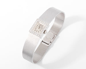 Montre Tissot or gris et diamant datant des années 1960