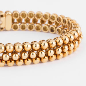 Bracelet or jaune 18k signé et numéroté de la maison Boucheron collection Grains de Raisin